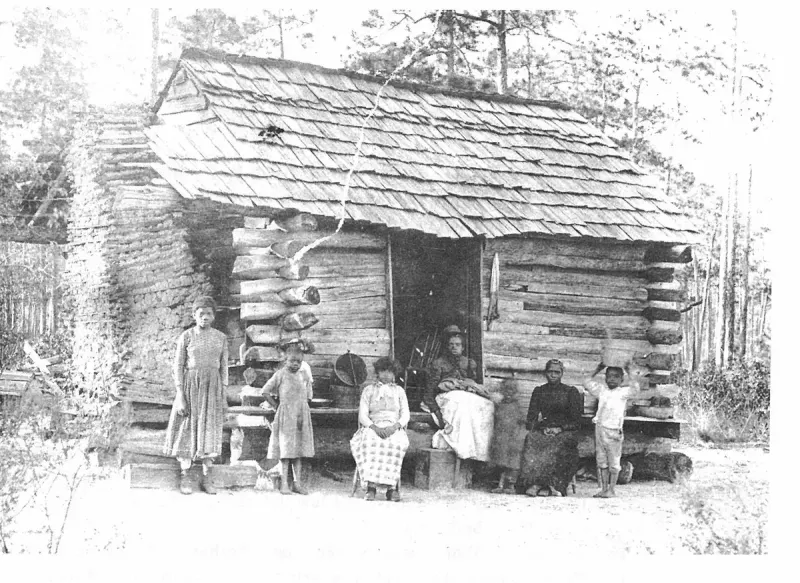 A typical log cabin, shack built for a colored family living at Hagan's turpentine still which was located