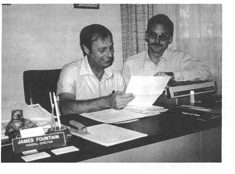 Robert W. Burkhart and James Fountain checking the list of sponsors for The First Hundred Years of Avon Park